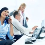 A young businesswoman on the phone at her desk on the office