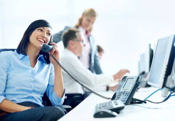 A young businesswoman on the phone at her desk on the office